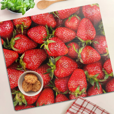 Tabla de cortar de cristal Fresas sobre fondo rojo