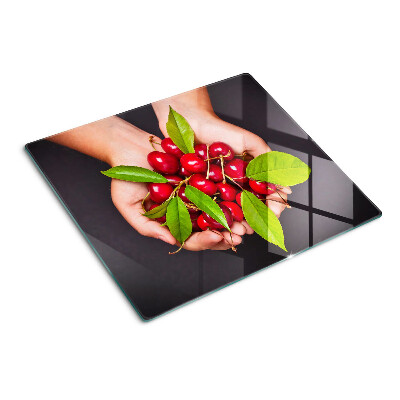 Tabla de cortar de cristal Cerezas rojas en las manos