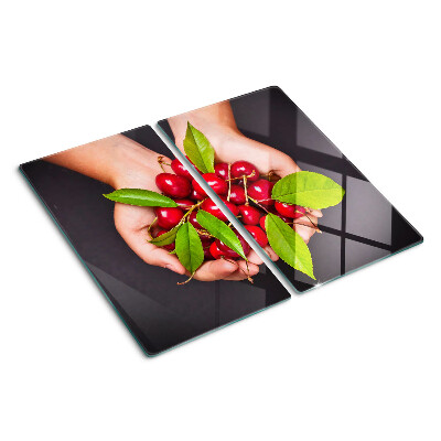 Tabla de cortar de cristal Cerezas rojas en las manos