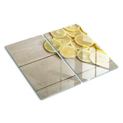 Tabla de cortar de cristal Rodajas de limón sobre un fondo de madera