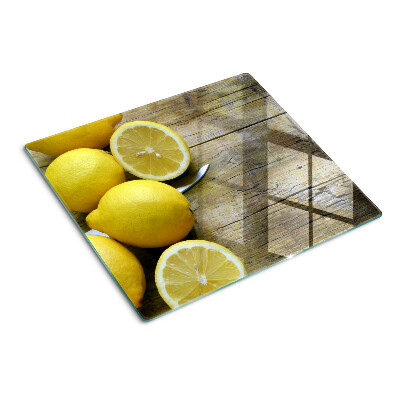 Tabla de cortar de cristal Limones sobre un fondo de madera