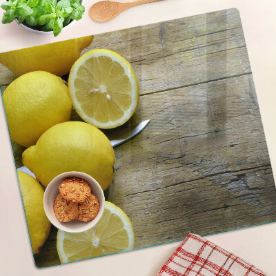 Tabla de cortar de cristal Limones sobre un fondo de madera