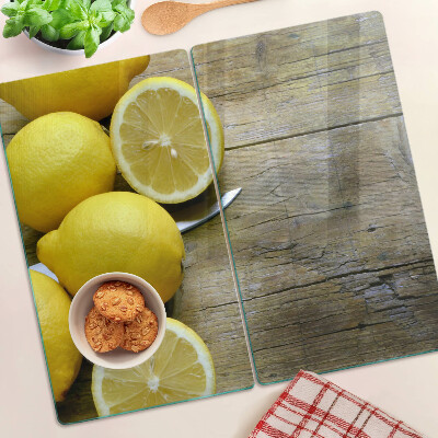 Tabla de cortar de cristal Limones sobre un fondo de madera