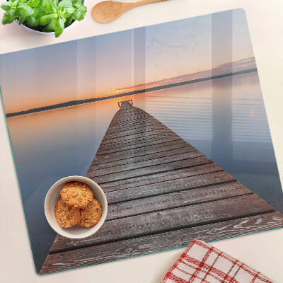 Tabla de cortar de cristal Muelle en el lago al atardecer