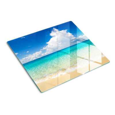 Tabla de cortar de cristal Playa con agua turquesa y nubes.