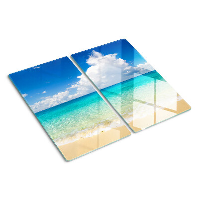 Tabla de cortar de cristal Playa con agua turquesa y nubes.