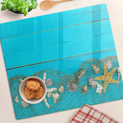 Tabla de cortar de cristal Conchas y estrellas de mar en una red