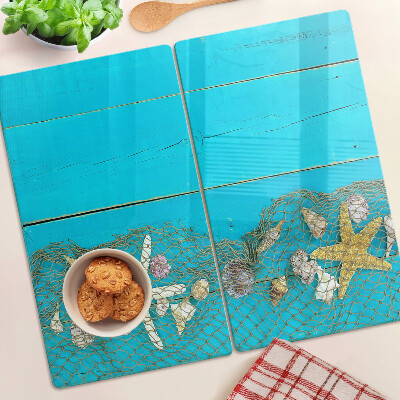 Tabla de cortar de cristal Conchas y estrellas de mar en una red