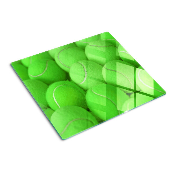 Tabla de cortar de cristal Pelotas de tenis sobre un fondo verde