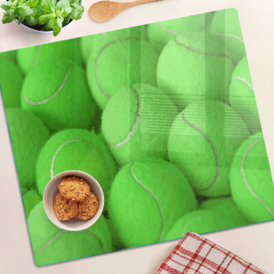 Tabla de cortar de cristal Pelotas de tenis sobre un fondo verde