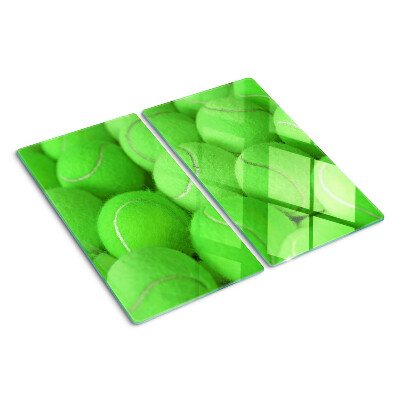 Tabla de cortar de cristal Pelotas de tenis sobre un fondo verde