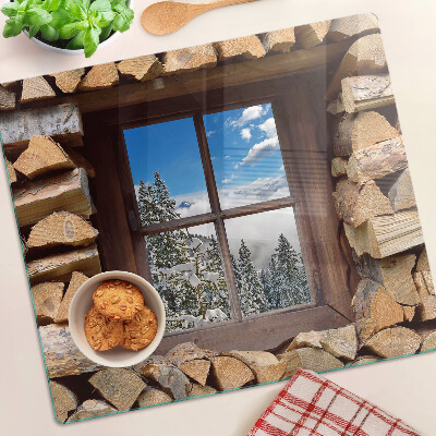 Tabla de cortar de cristal Vista de un paisaje invernal a través de la ventana.