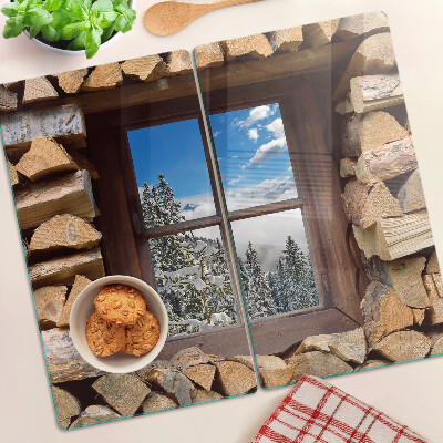 Tabla de cortar de cristal Vista de un paisaje invernal a través de la ventana.