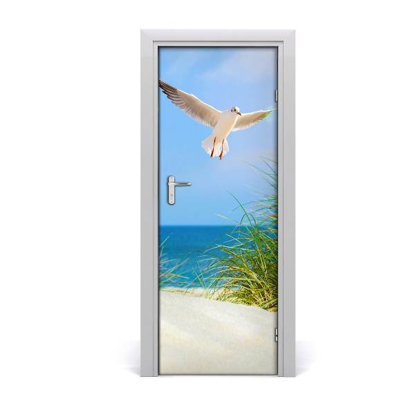 Vinilo para puerta Gaviota sobrevolando las dunas