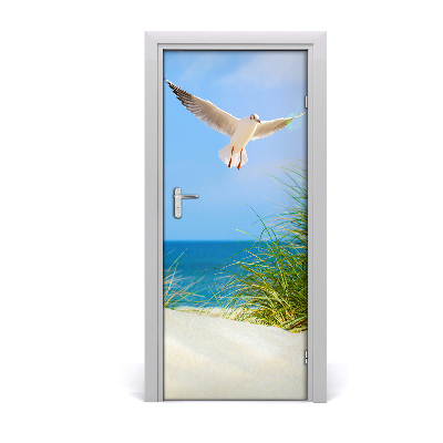 Vinilo para puerta Gaviota sobrevolando las dunas