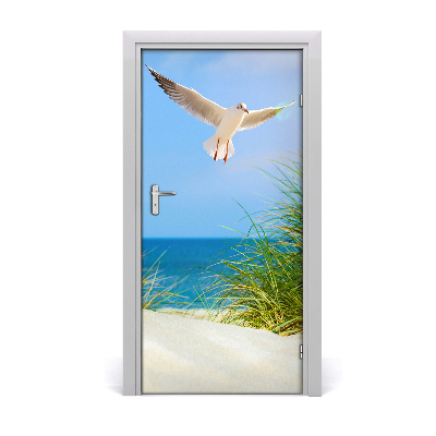Vinilo para puerta Gaviota sobrevolando las dunas