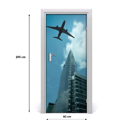 Pegatina para puerta Avión sobrevolando la ciudad