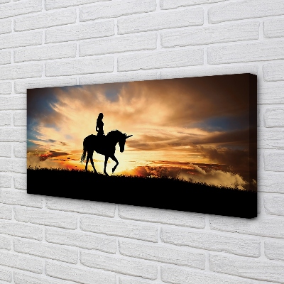 Cuadros sobre lienzo Mujer en la puesta del sol unicornio