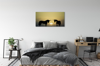 Cuadros sobre lienzo Unicornios puesta de sol sobre el terreno