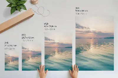 Póster superficie de agua en calma con colores cálidos del cielo y un puente