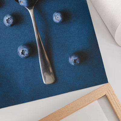 Póster con colores saturados Arándanos en una cuchara sobre fondo azul, elegancia