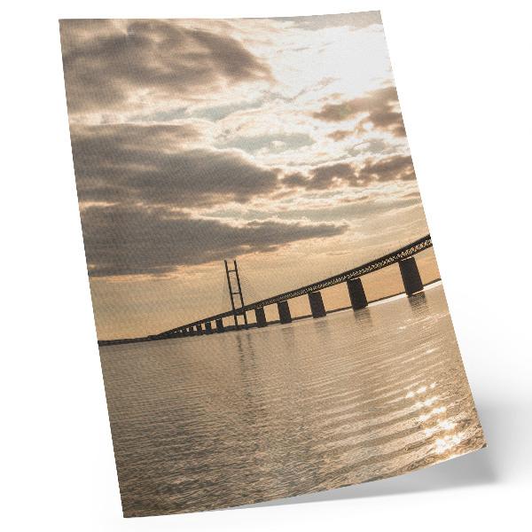 Póster Un puente sobre el agua a la luz del sol poniente.