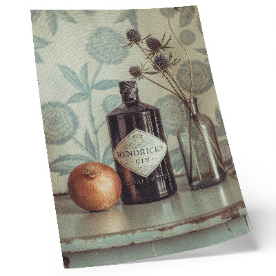 Lámina artística de alta calidad Una botella con un estampado floral en el fondo.