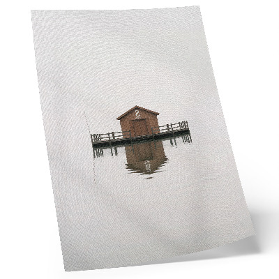 Lienzo decorativo moderno Una cabaña de madera de estilo minimalista junto al agua.