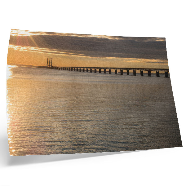 Póster Un puente en el horizonte iluminado por el sol.