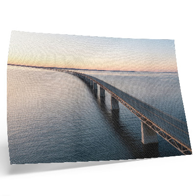 Arte de pared Un puente sobre un mar en calma al atardecer.