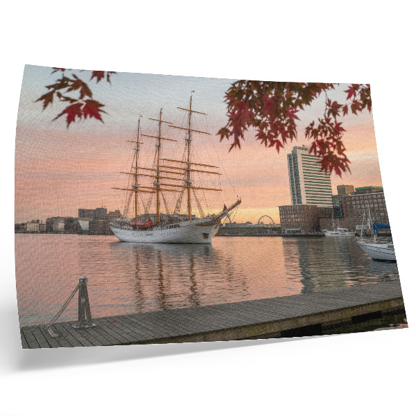 Arte de pared Un velero al atardecer, un panorama tranquilo de la ciudad.