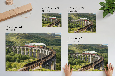Lámina para cuadro Un viaducto con un tren entre verdes colinas.