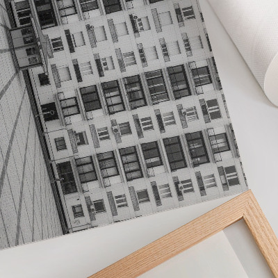 Póster Un edificio moderno con balcones y una plaza.