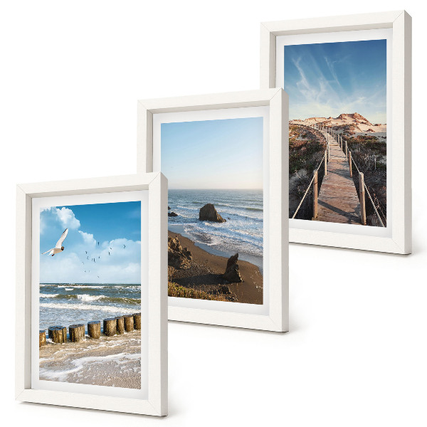 Juego de 3 cuadros decorativos Vista de la playa con olas, cielo y un muelle.