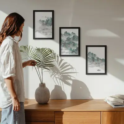 Juego de 3 cuadros decorativos con diseño de montañas entre las nubes con pájaros y barco estilo japandi