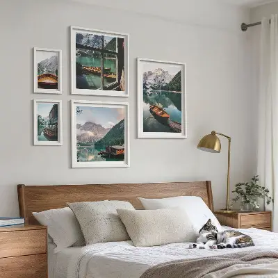 Pared galería de arte con motivos de lagos, montañas, barcos y paisajes